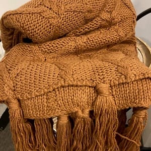 Caramel coloured knitted throw