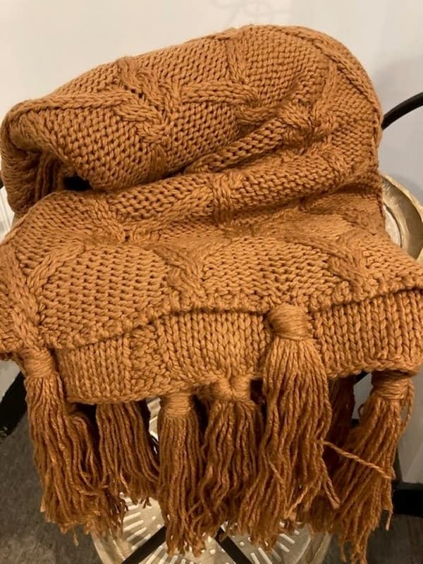 Caramel coloured knitted throw